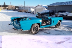 Unfinished 1956 Ford T-bird outside on a sunny day