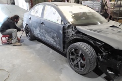 Technician re-radiusing an Evo X rear wheel