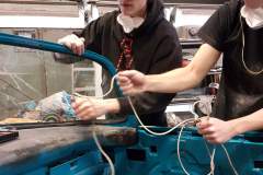 Four hands are better than two and two heads can teamwork better than one!  Our apprentices make "roping in" this 1956 T-Bird's windshield look easy!